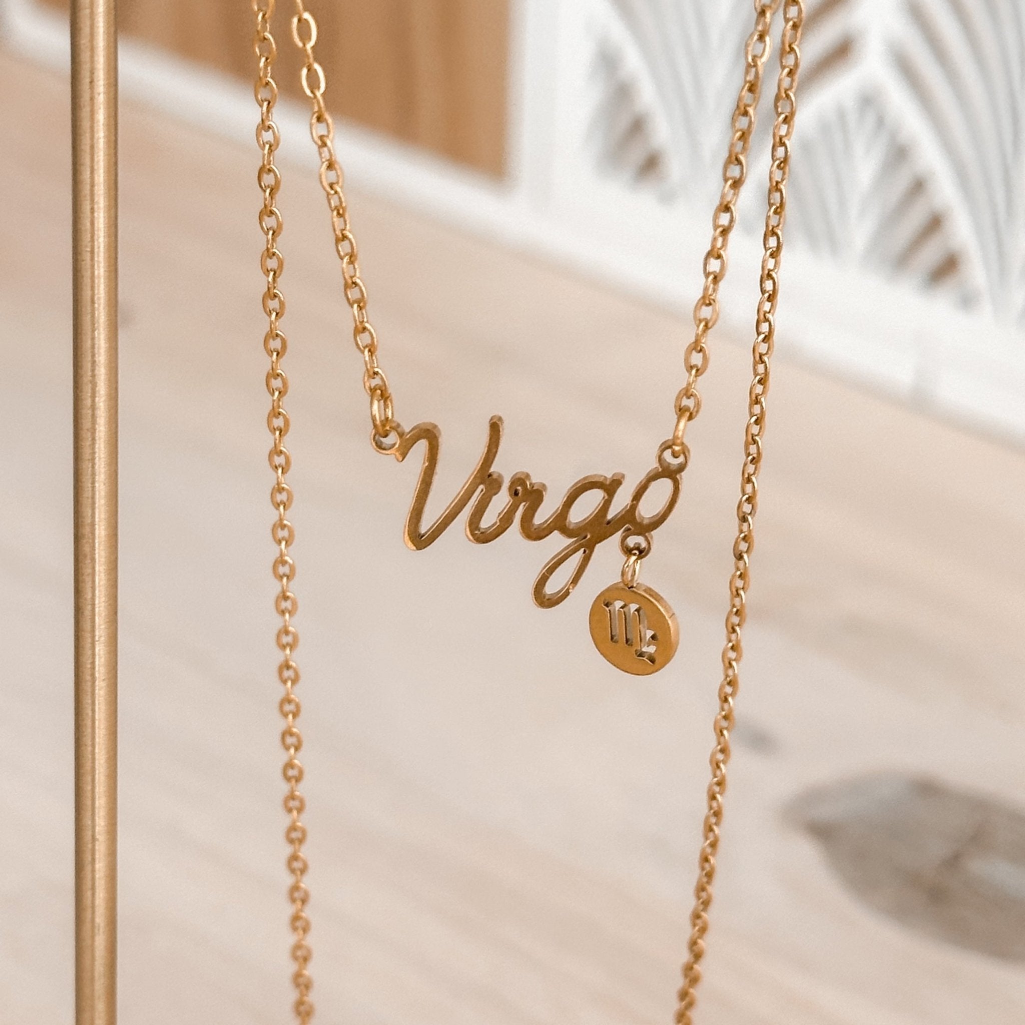 Virgo zodiac necklace with pendant detail on a jewelry display