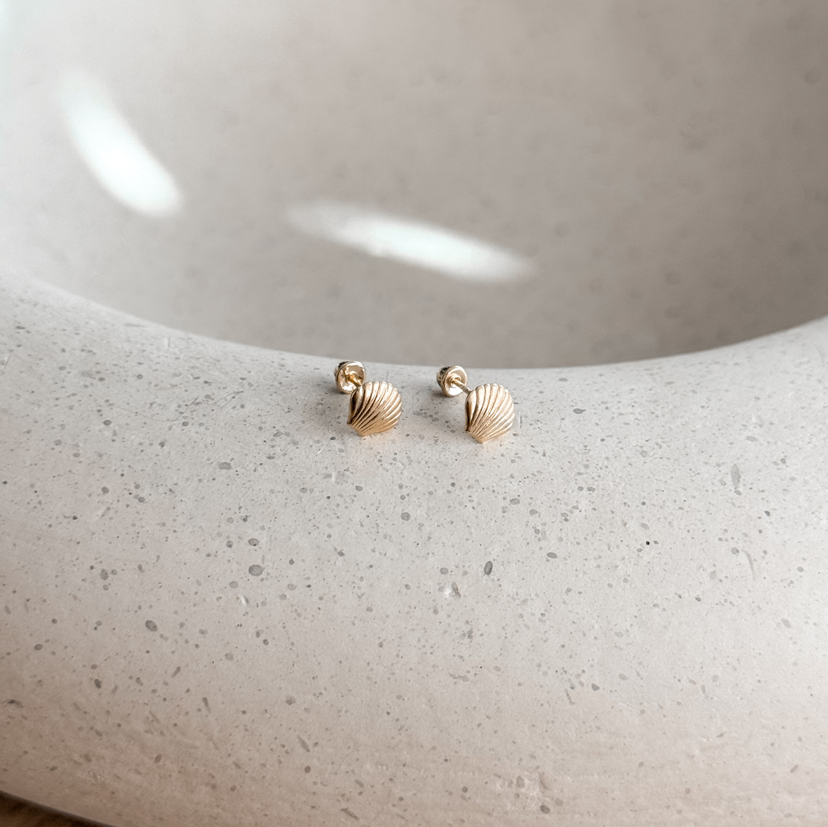 10K solid gold seashell studs with screw backs on a stone dish, side view – Liv Aura