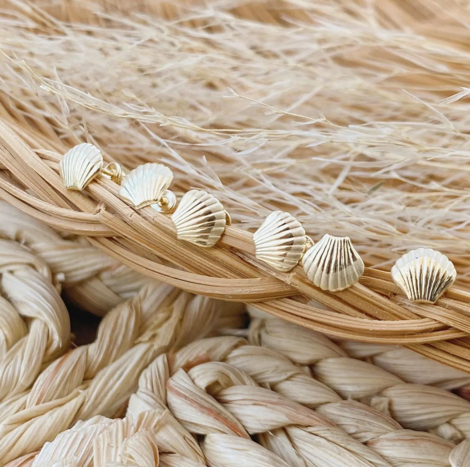 10K solid gold seashell stud earrings displayed on a woven straw tray – Liv Aura