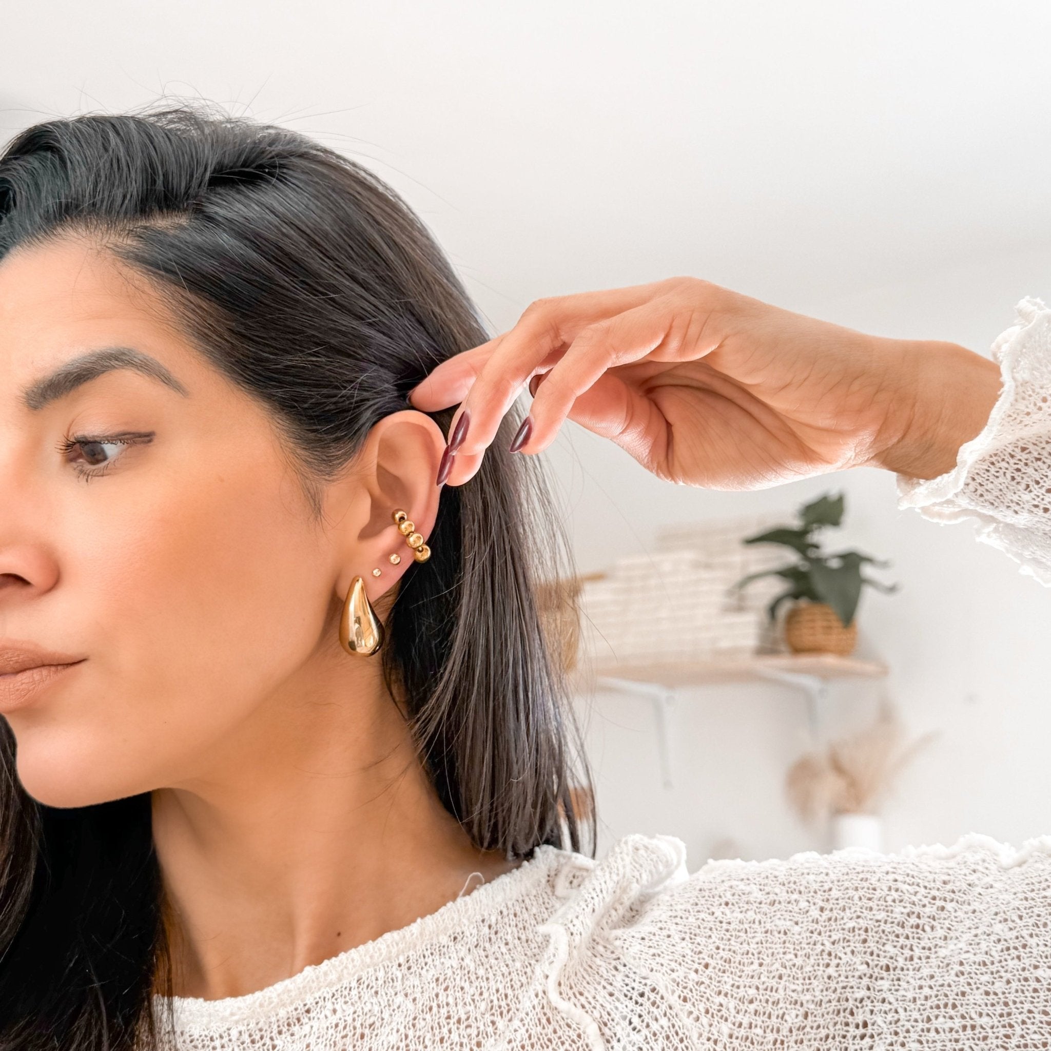 Model wearing Ava Drop Earring in gold – bold teardrop stud for modern statement look