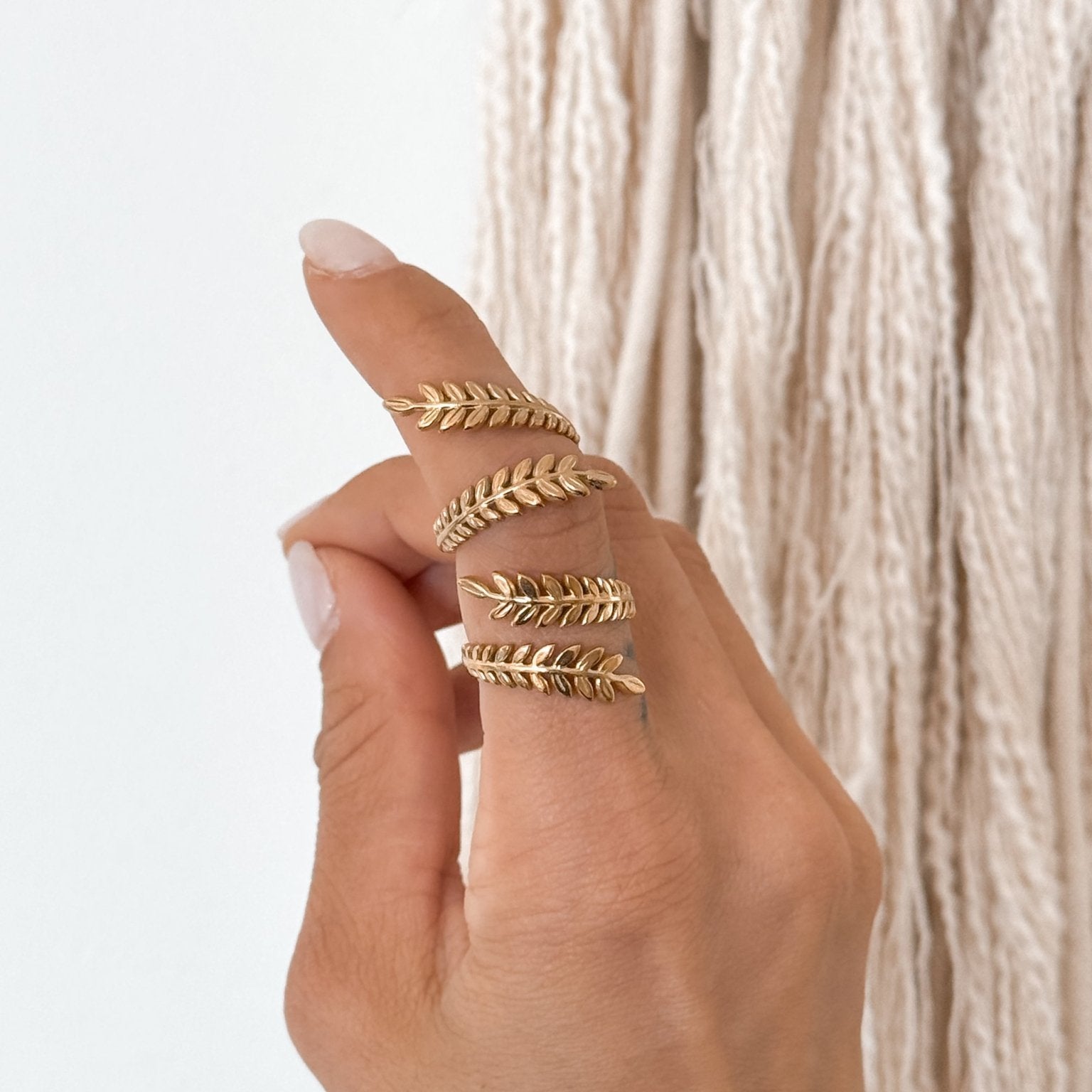 18K gold leaf wrap ring held on fingers – lightweight, adjustable, and hypoallergenic design