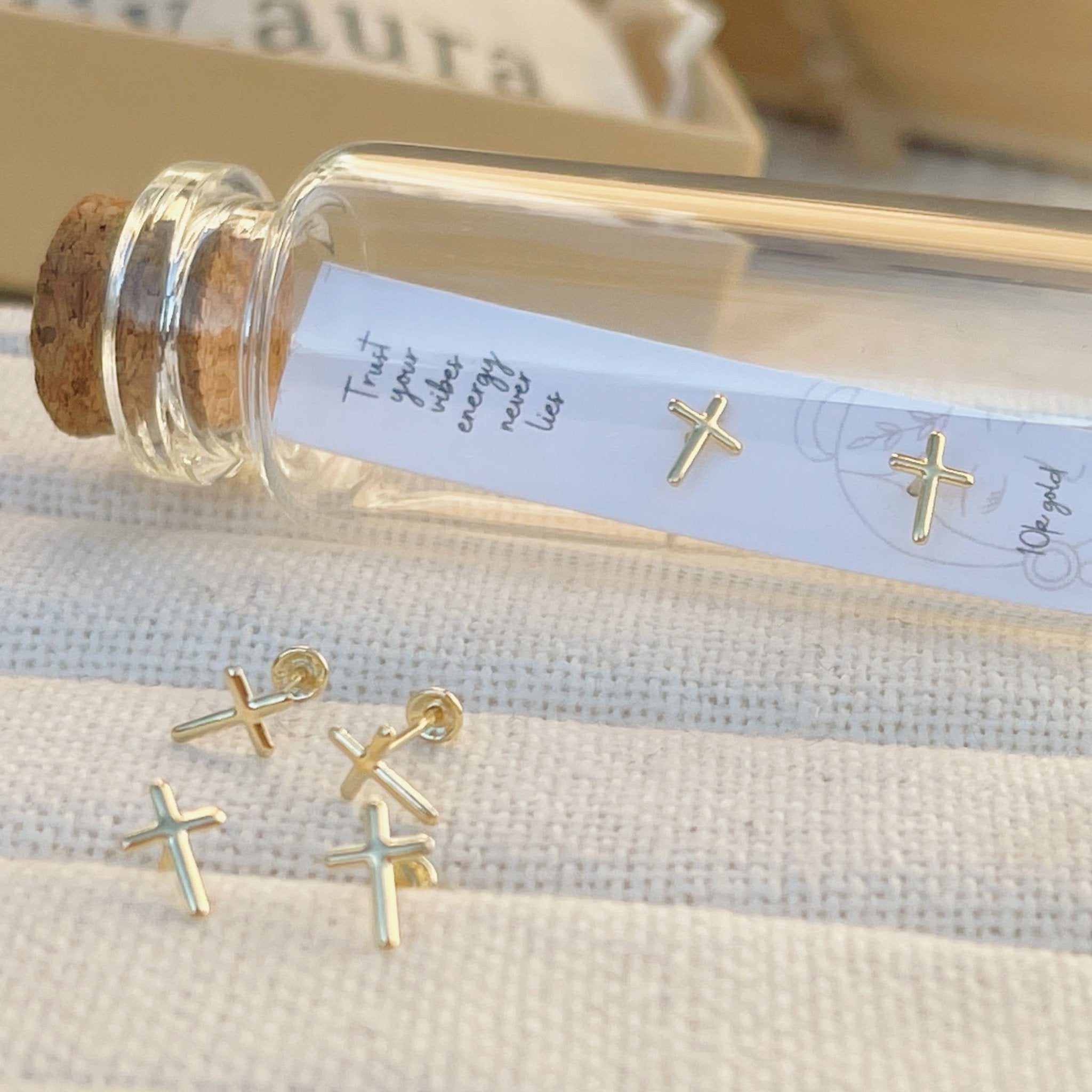 10K gold cross stud earrings inside glass vial, dainty packaging for gifting