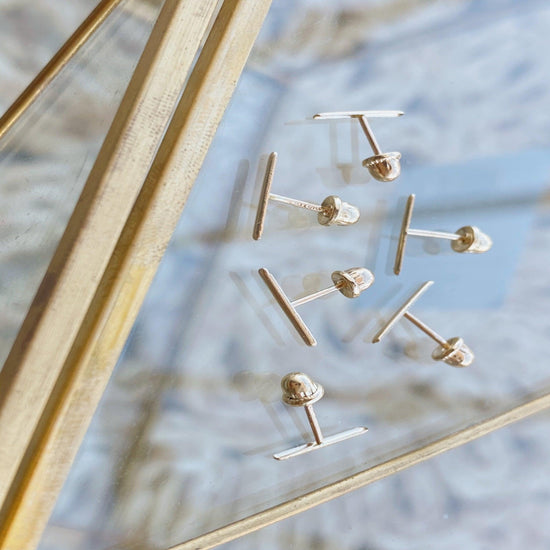 10k Gold Bar Stick Earrings is the perfect minimal earring. Easy to wear, they are a sleek and modern pair of earrings that add sparkle to any look.