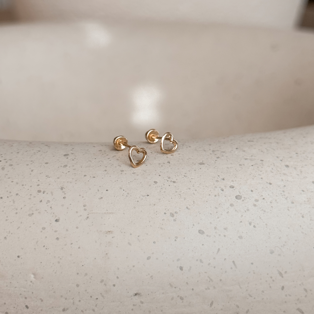10K solid gold open heart stud earrings with screw backs on a speckled stone dish – Liv Aura