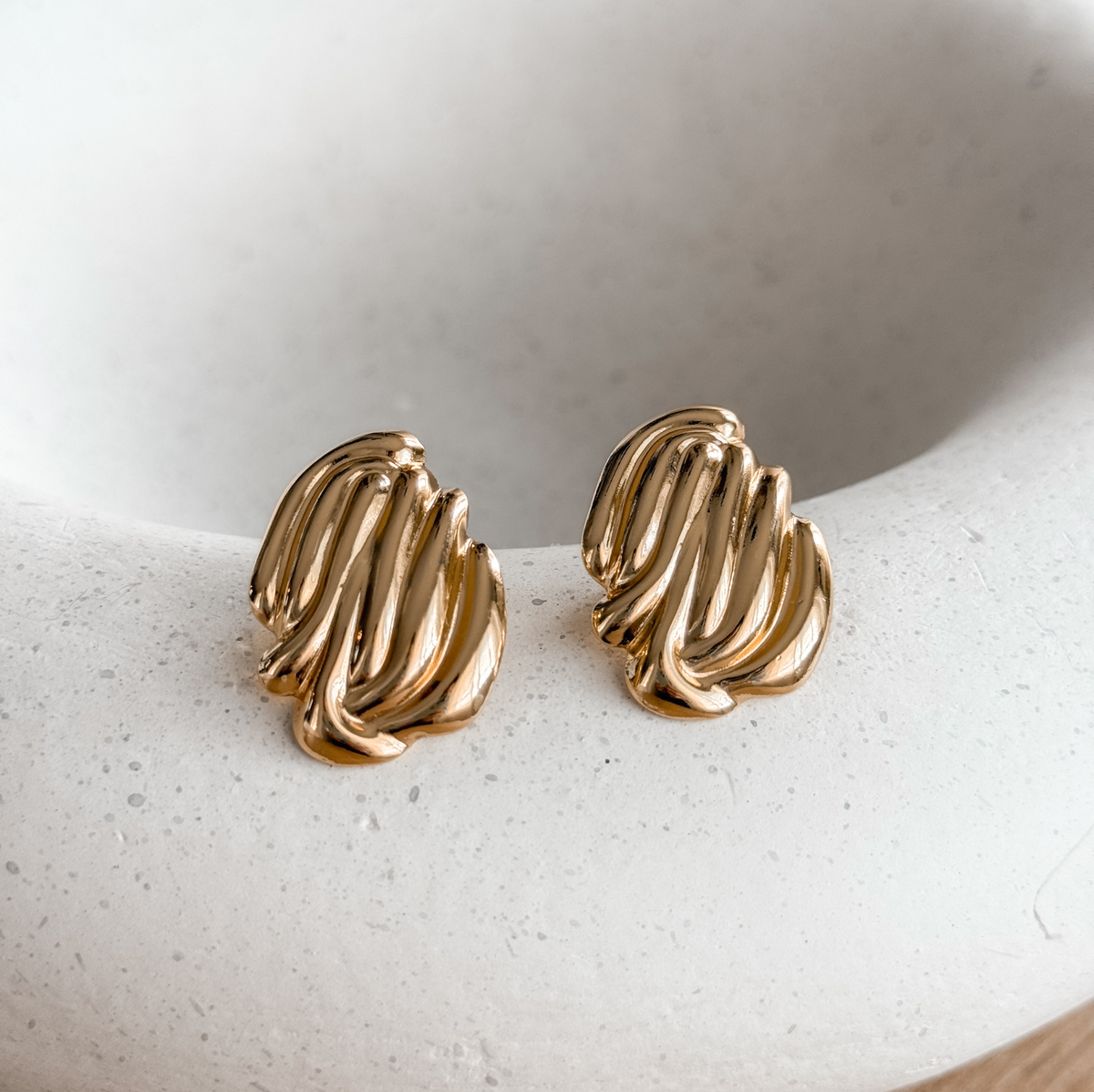 18K gold plated ribbed statement stud earrings on a stone dish – Liv Aura
