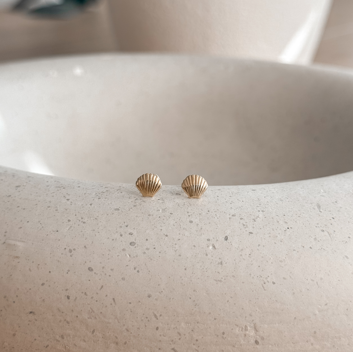 10K solid gold seashell stud earrings on a speckled stone dish – Liv Aura
