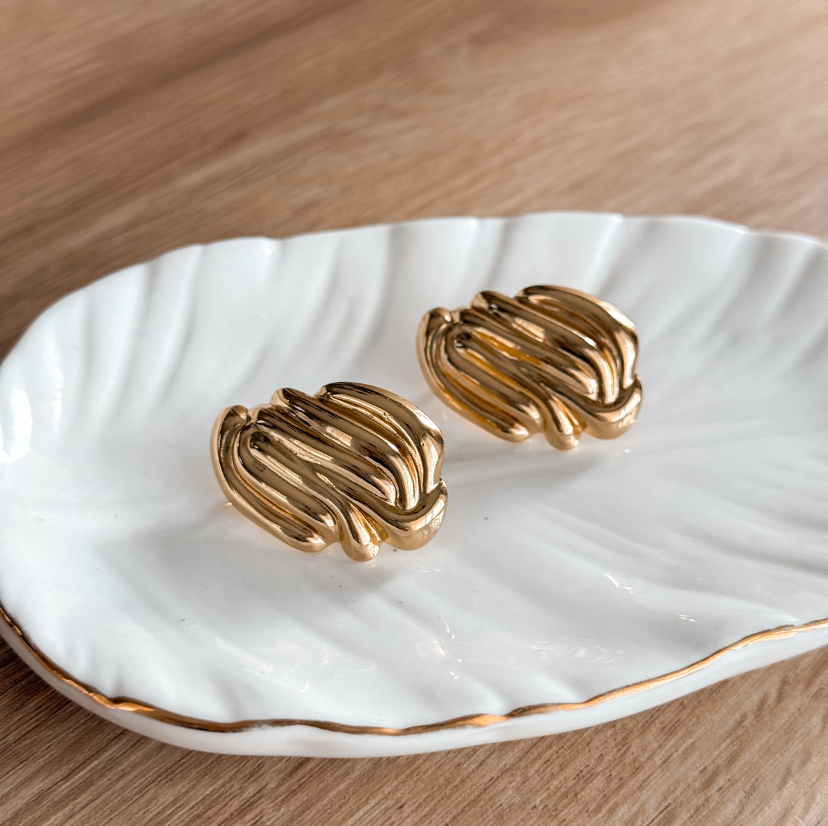 18K gold plated ribbed statement stud earrings on a white dish – Liv Aura