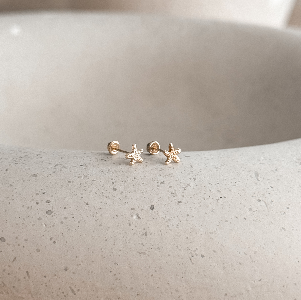 10K solid gold starfish studs with screw backs on a stone dish, side view – Liv Aura