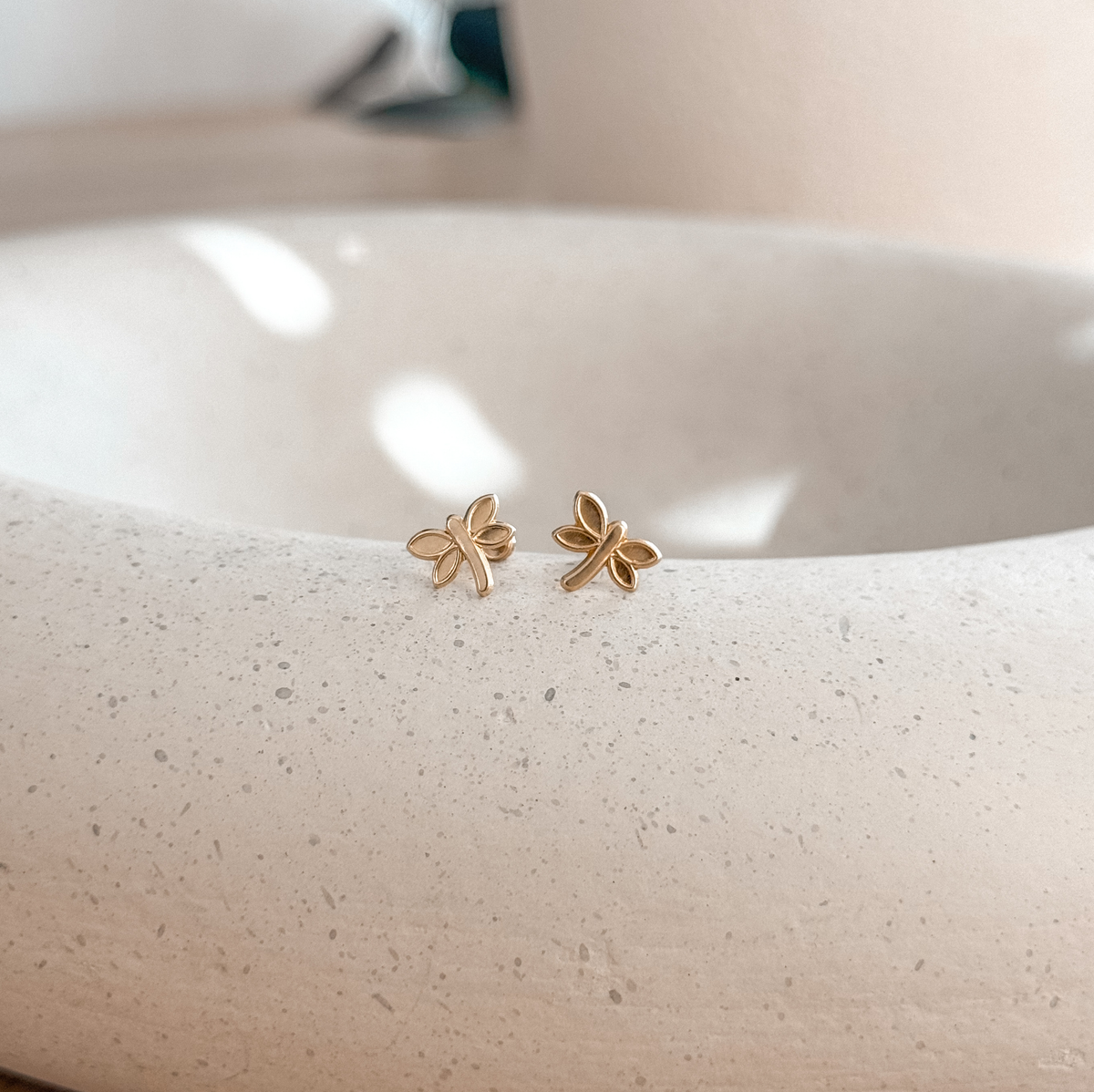 10K solid gold dragonfly studs with screw backs on a stone dish, side view – Liv Aura