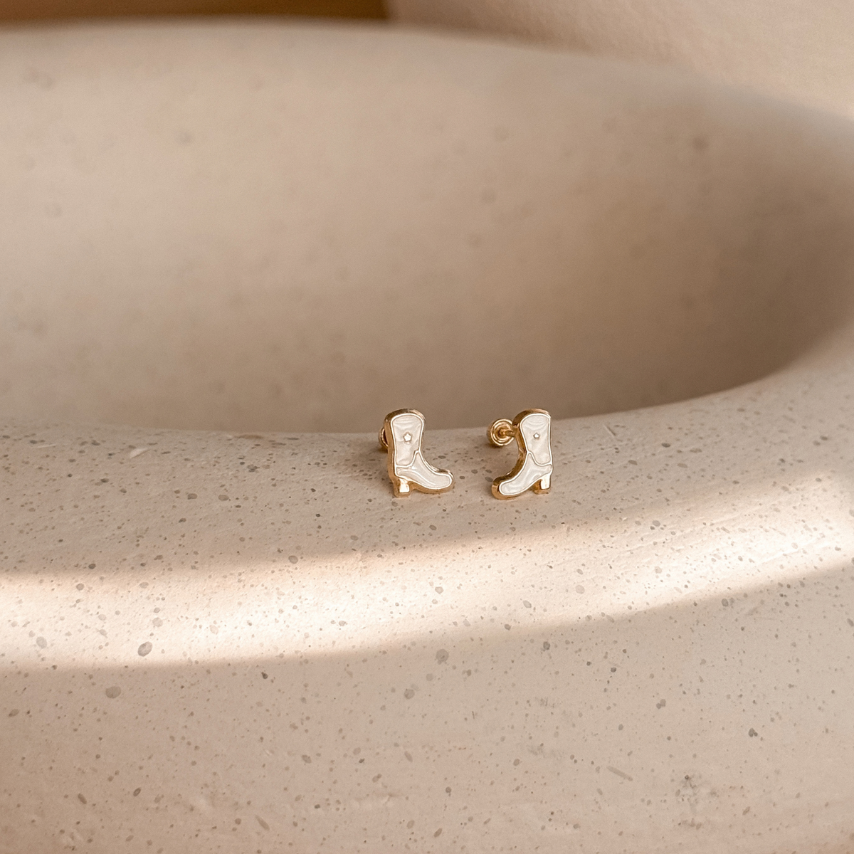 10K solid gold cowboy boot stud earrings with white enamel on a stone dish – Liv Aura