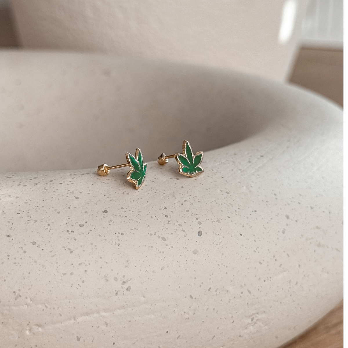 10K solid gold green leaf stud earrings on a stone dish – Liv Aura