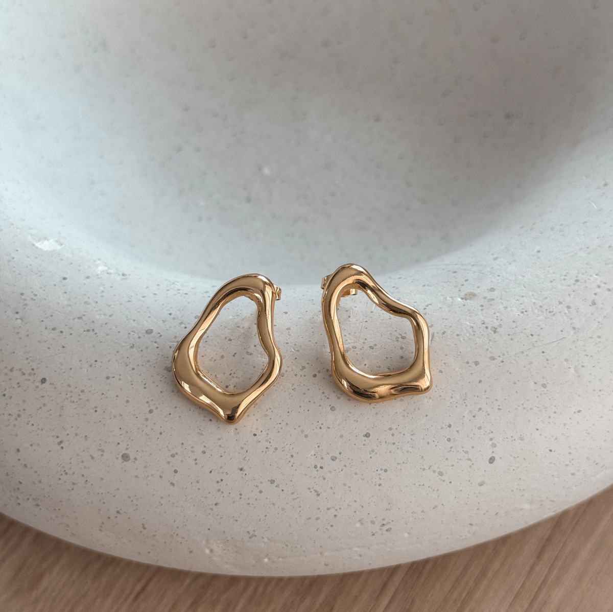 18K gold plated organic open stud earrings on a speckled stone dish – Liv Aura
