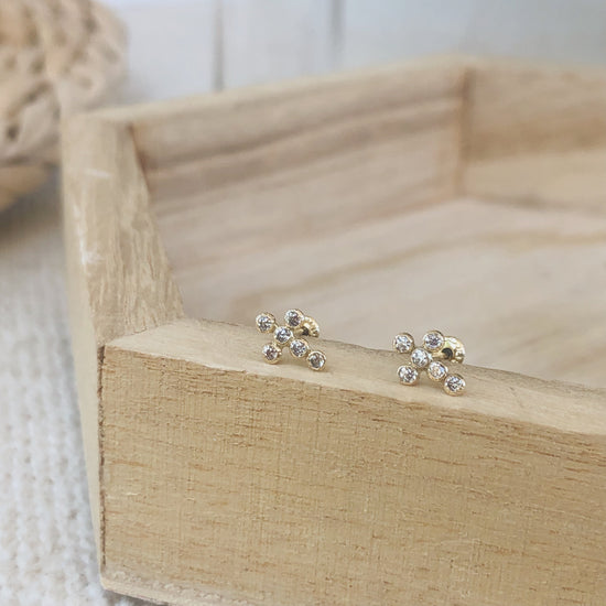 Load image into Gallery viewer, Simple and classy 10K gold-filled cross earrings perfect for any occasion. These studs can easily be worn all day long without the discomfort that real earrings sometimes cause.
