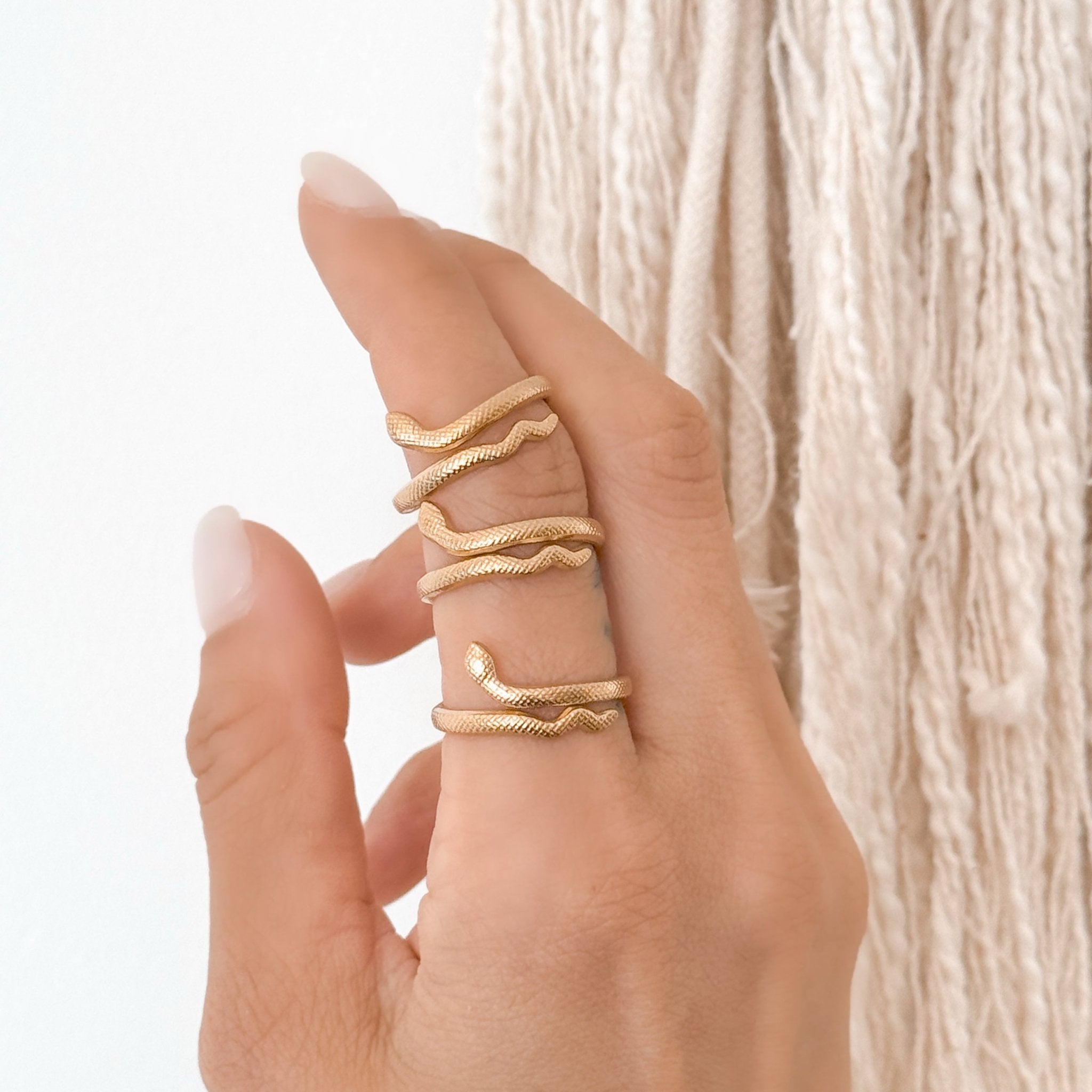 Minimalist snake ring worn on hand – adjustable 18K gold ring perfect for stacking and everyday style