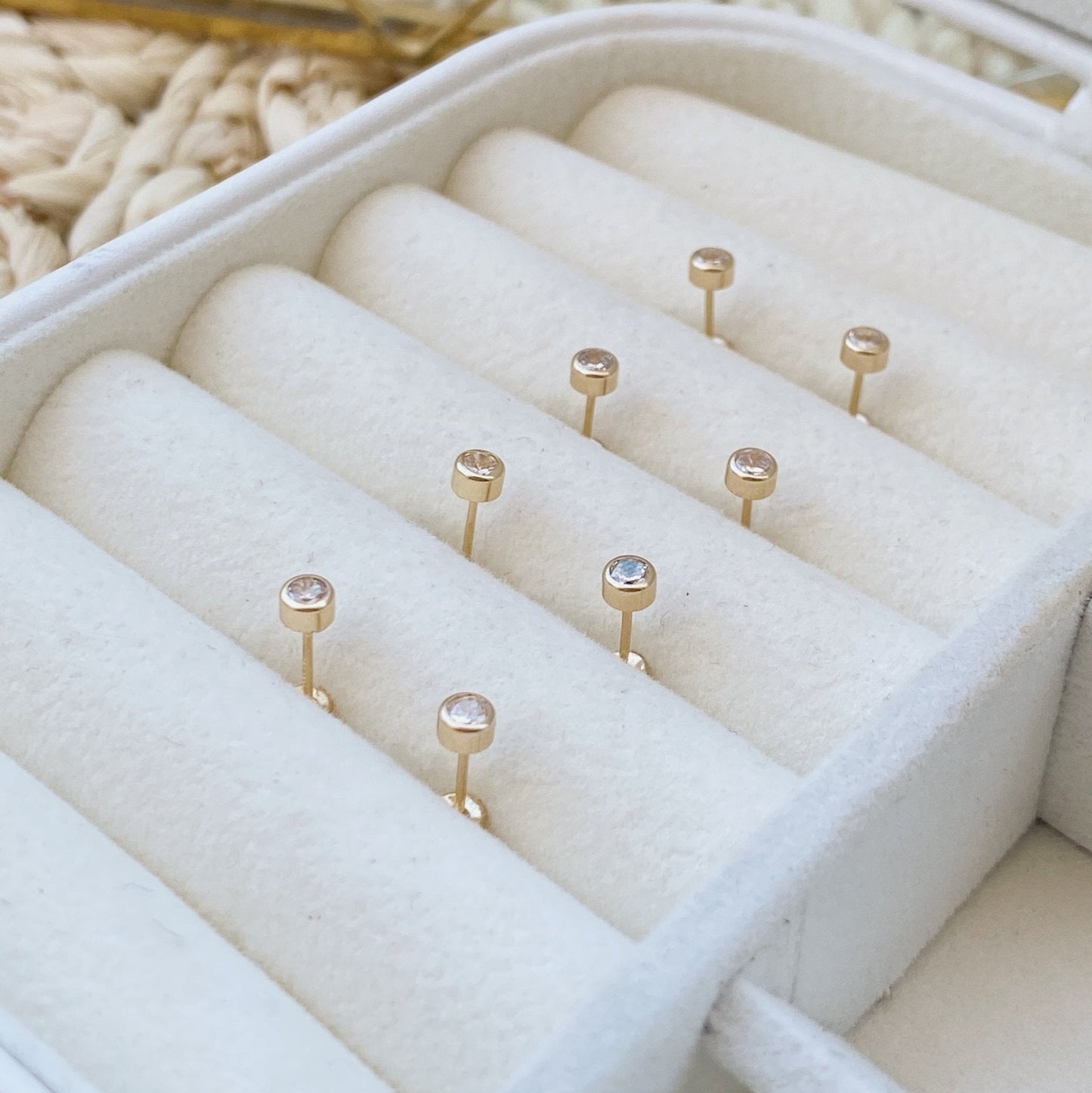 Load image into Gallery viewer, These 14K gold bezel stud earrings are perfect for adding a little something to your everyday outfit. They are dainty and minimal, but still make a statement! These studs are great for the helix piercing and other piercings that need a really flat back.
