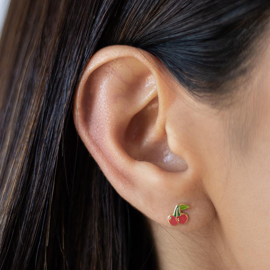 Load image into Gallery viewer, These dainty cherry stud earrings are a great gift for those who have a sweet tooth or love the summer season! These gold red cherry earrings are made with high quality 10K gold. 
