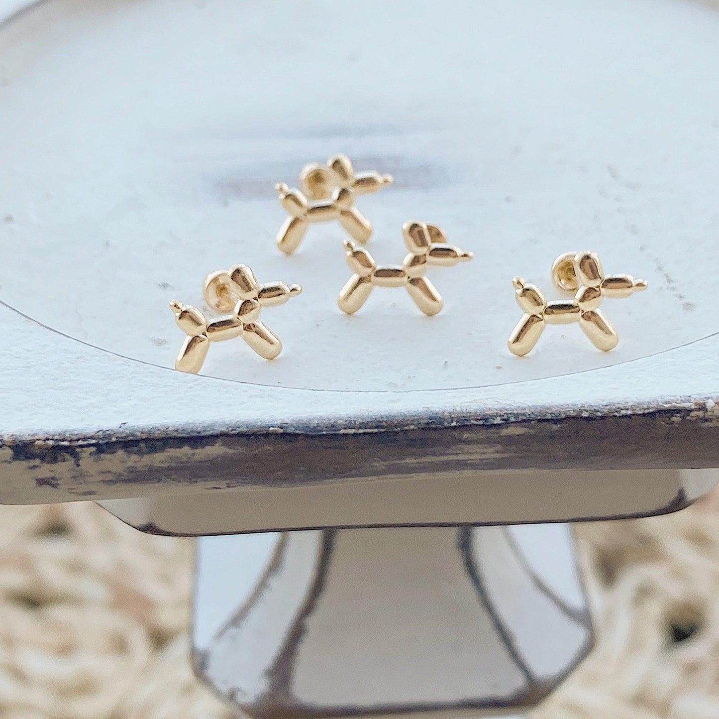These gold dog earrings are perfect for anyone who loves dogs! They can be worn with jeans, or formal attire. The earrings arrive in a little glass bottle to make them a great gift for any occasion.