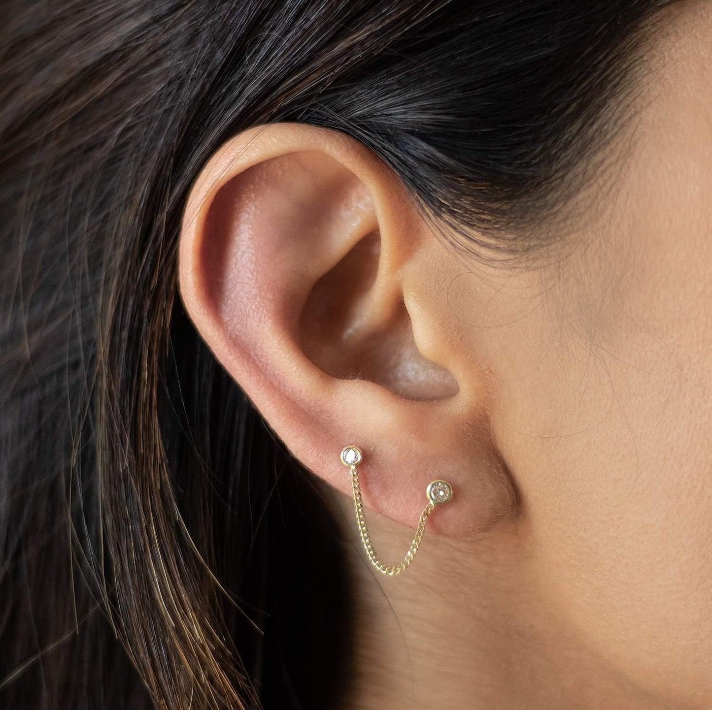 This beautiful earring will catch the attention of everyone in the room. It's made with a 10k gold chain and double circle pendant. This double piercing earring can be worn by women who have multiple piercing in their ears to add an extra decorative touch.