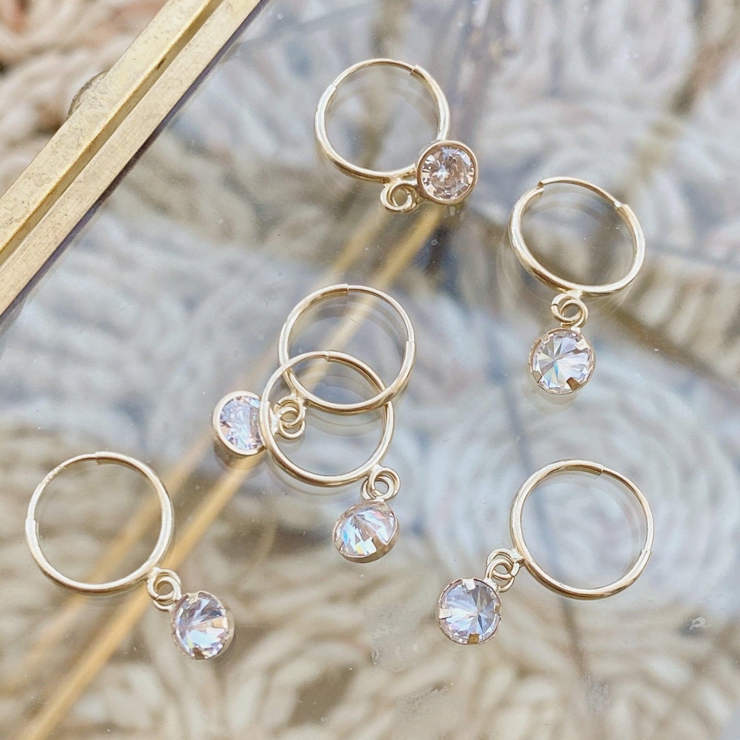 Load image into Gallery viewer, hoop earring with bezel CZ circle,Unique hoop earrings Made from 10K Huggie Hoop Earrings, they fit comfortably in your earlobes and have a beautiful design that is guaranteed to make heads turn when you step out on the town.
