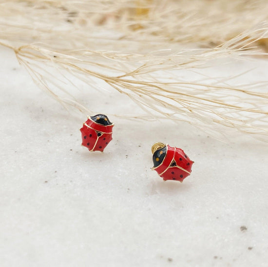 Load image into Gallery viewer, Perfect for your little ladybug, these screw back earrings will let everyone know that she is one lucky girl. They are made from gold and enamel, giving this jewelry a perfect finish fit for the most elegant of girls!
