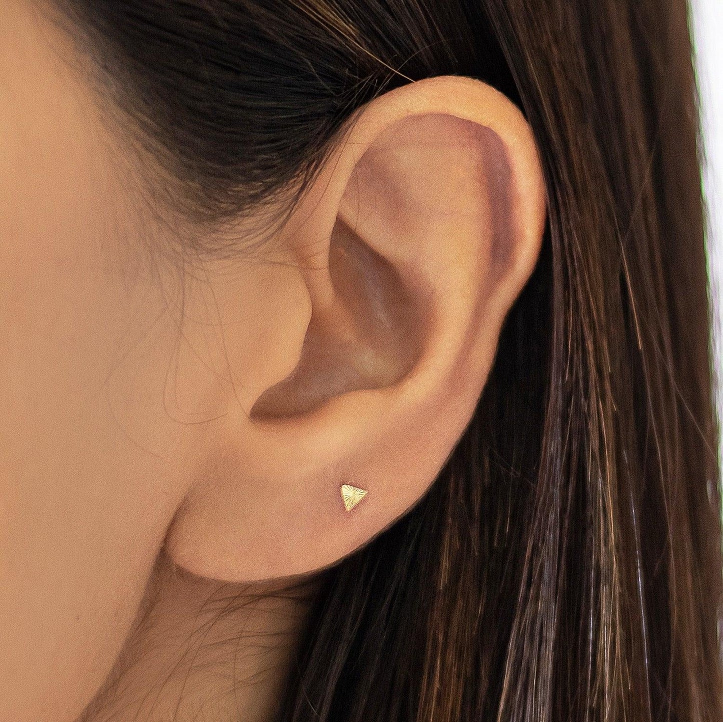 These triangle earrings are crafted from 10k gold, and feature a small triangle design. They are great for second hole piercings or cartilage piercings. You can wear them with any outfit for a clean and fresh look.