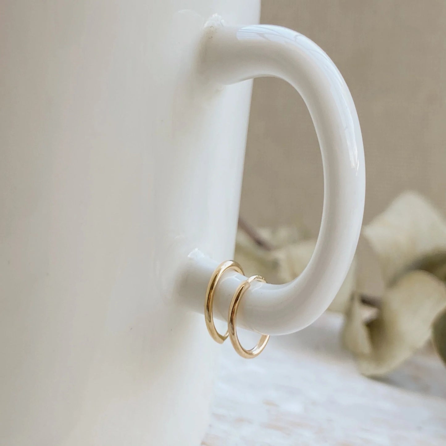Load image into Gallery viewer, Huggie Hoop Earrings are the perfect huggie hoops that are made to look great and comfortable while you wear them. Hoops like these will make your ears look dainty and cute, yet classy and elegant all at once!
