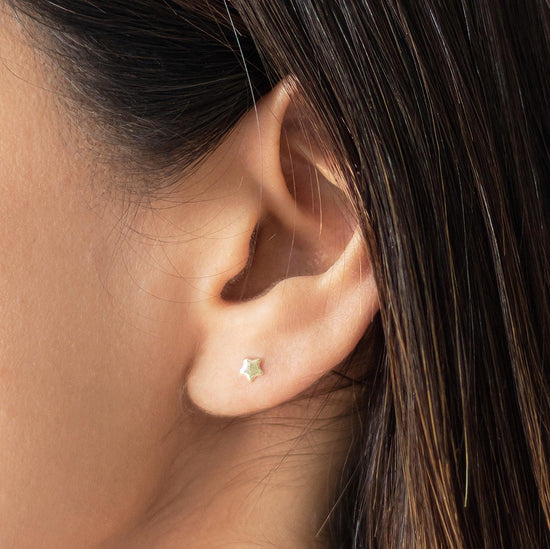 Load image into Gallery viewer, These Tiny Star Earrings are perfect for everyday wear. They are lightweight and the earrings are made of real gold which makes them beautiful and valuable.
