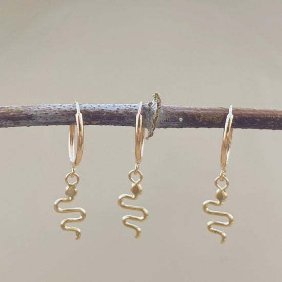 These snake hoop earrings are a chic, modern take on the classic hoop earring. These snake earrings feature a unique snake design with a bright gold finish and shiny 10k gold setting that adds luxe style to your look. 