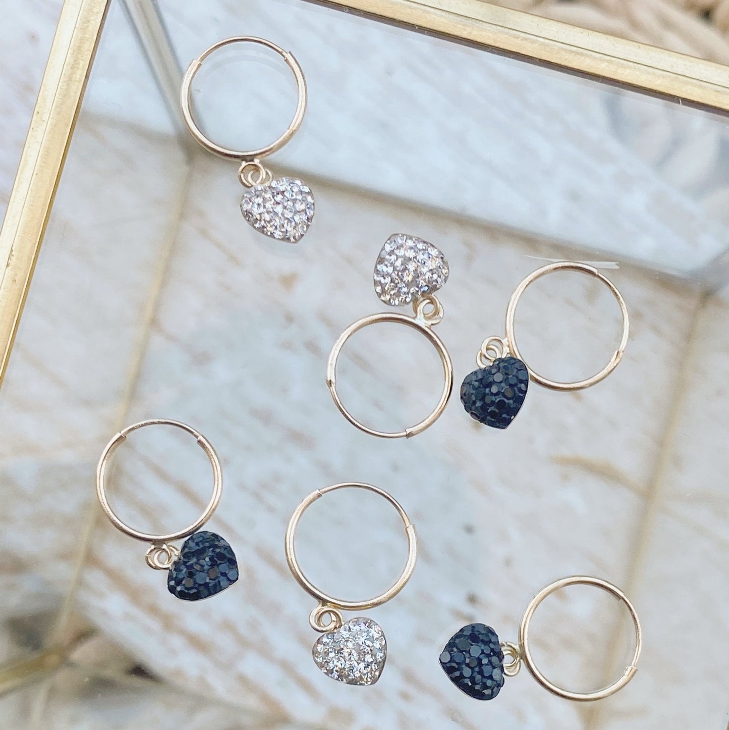This set of heart earrings features a gold hoop and heart dangle drop. Our 10K gold huggie hoops are perfect for cartilage piercings or any other earring holes. A gorgeous addition that is sure to catch attention and make you feel beautiful!