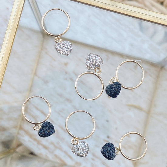 This set of heart earrings features a gold hoop and heart dangle drop. Our 10K gold huggie hoops are perfect for cartilage piercings or any other earring holes. A gorgeous addition that is sure to catch attention and make you feel beautiful!