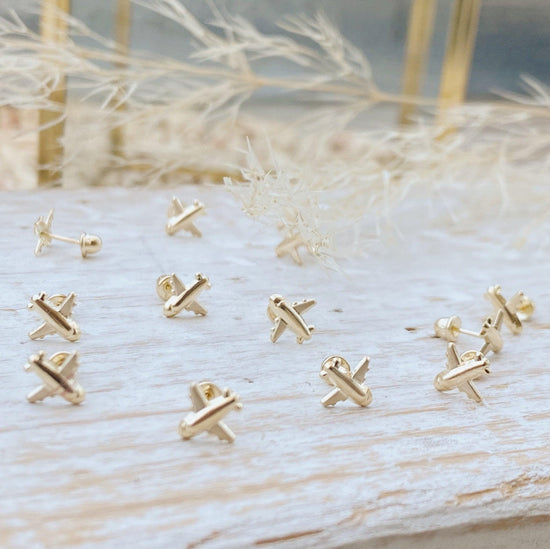 These earrings are perfect for those who love to travel. They are a beautiful reminder of all the planes you have been on and all the places you have visited, while also being minimalistic and stylish. These gold air plane earrings are made from solid 10K gold and screw backs that make them easy to wear.