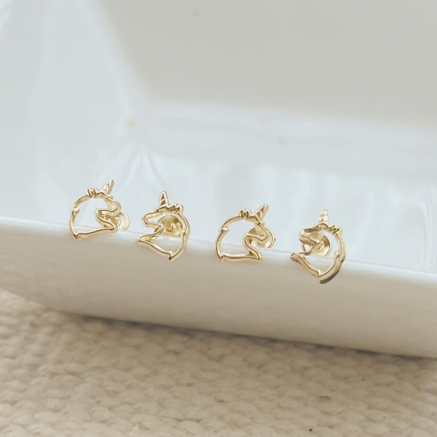 Load image into Gallery viewer, Our Gold Unicorns Earrings are the perfect gift for girls. These gold unicorn stud earrings have a screw backing 
