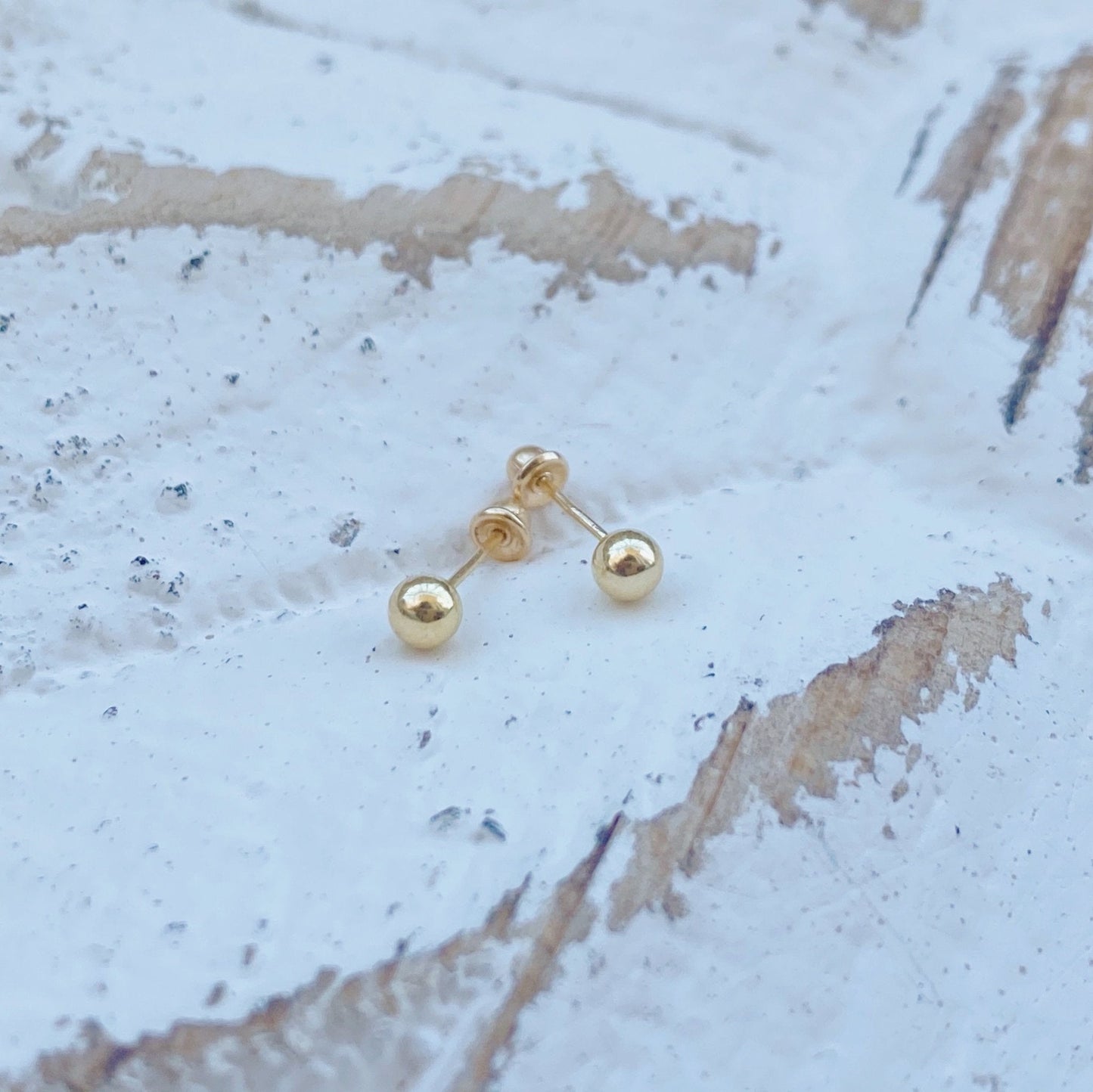 Load image into Gallery viewer, This is a pair of solid 10K gold earrings in gold disco ball shape. They are 2mm and 3mm, which can be adjusted to your preference. The perfect size for every day wear and has screw backs to avoid losing them while sleeping.
