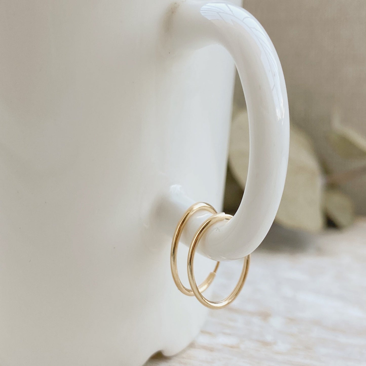 These 14k gold hoop earrings are the perfect gift for yourself or a friend. The lightweight design makes these hoops comfortable to wear all day long, and the simple gold color is sure to complement your aesthetic.