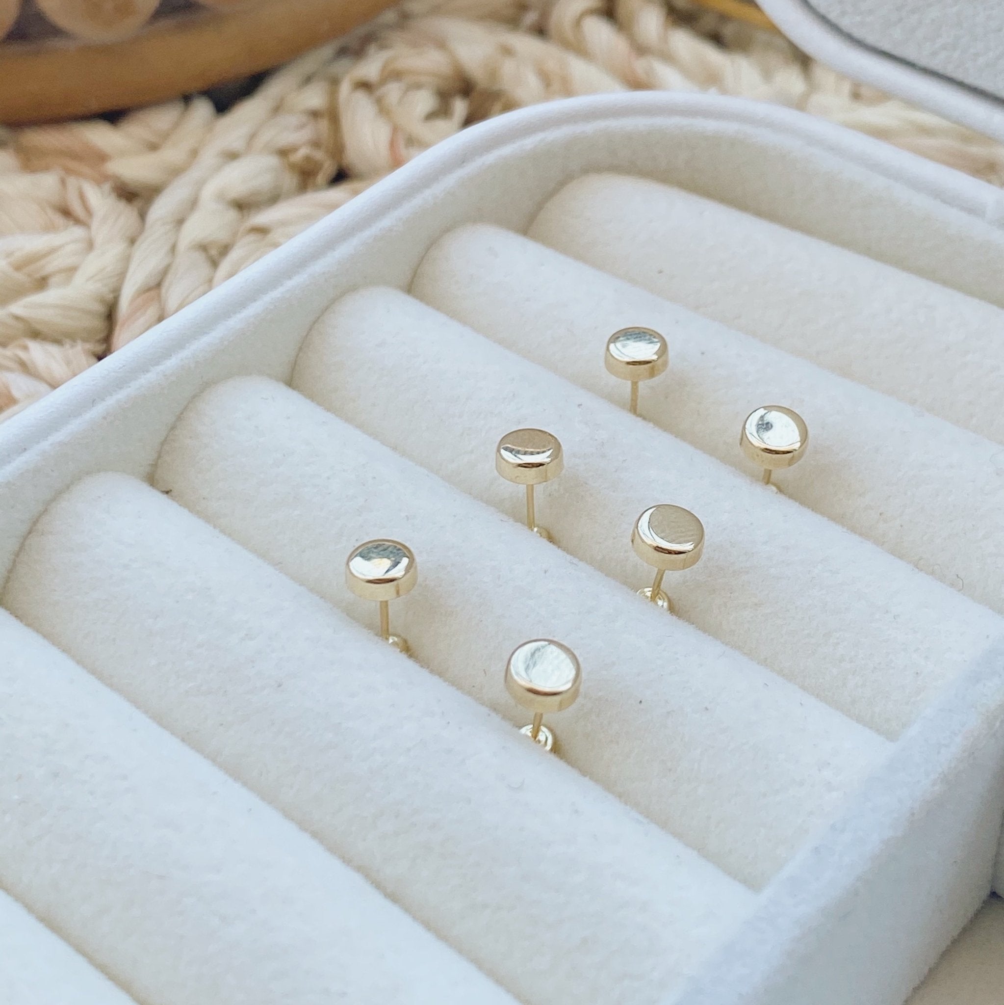 Three gold dot stud earrings inside a soft jewelry case – 10K solid gold minimalist studs