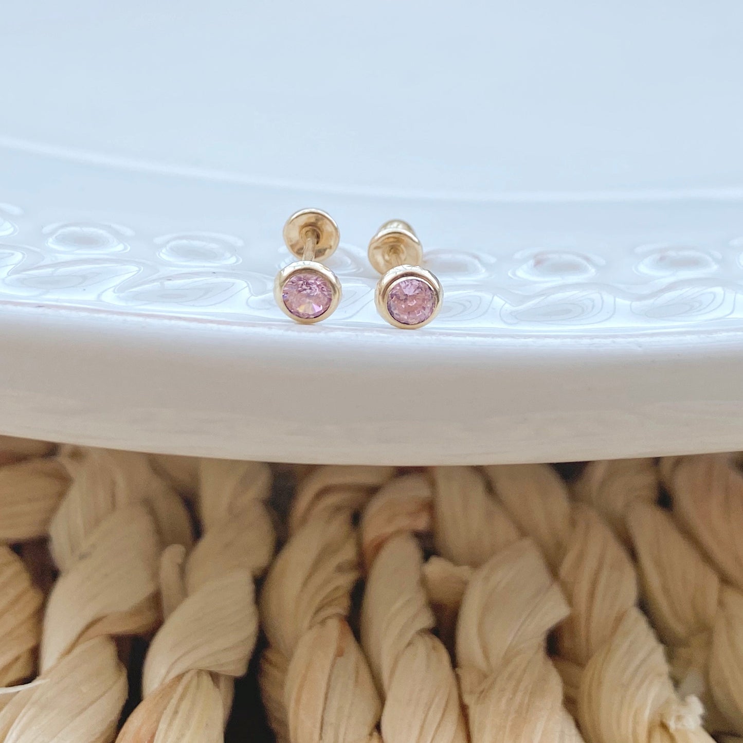 These solid gold stud earrings are set with a 3mm bezel and are perfect for everyday wear. They have a screw back for extra security, so they won't fall out or get lost. These tiny bezel set cubic zirconia diamond earrings make the perfect gift for everyone on your lis