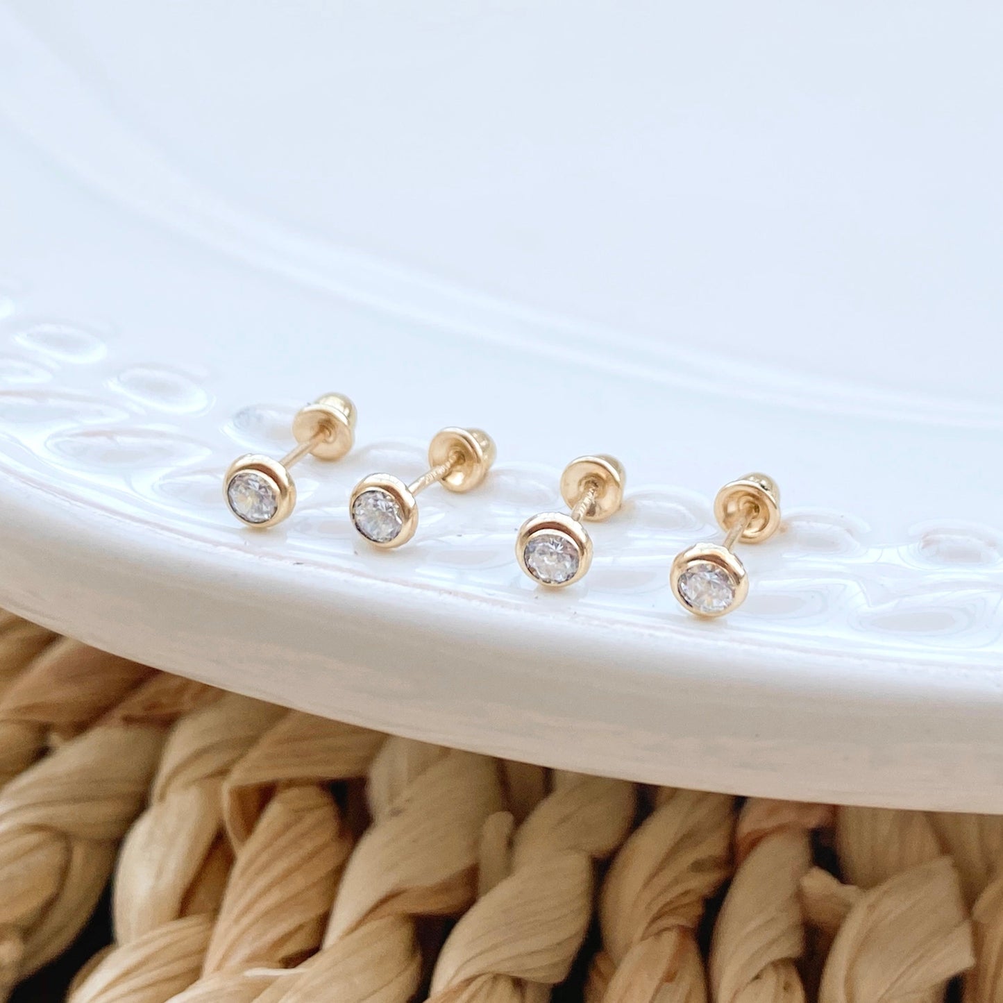 Load image into Gallery viewer, Our 14K solid gold bezel stud earrings are the perfect size for a unisex gift or women&amp;#39;s everyday wear. These tiny gold stud earrings have 3mm bezel setting and are crafted from polished solid gold. 
