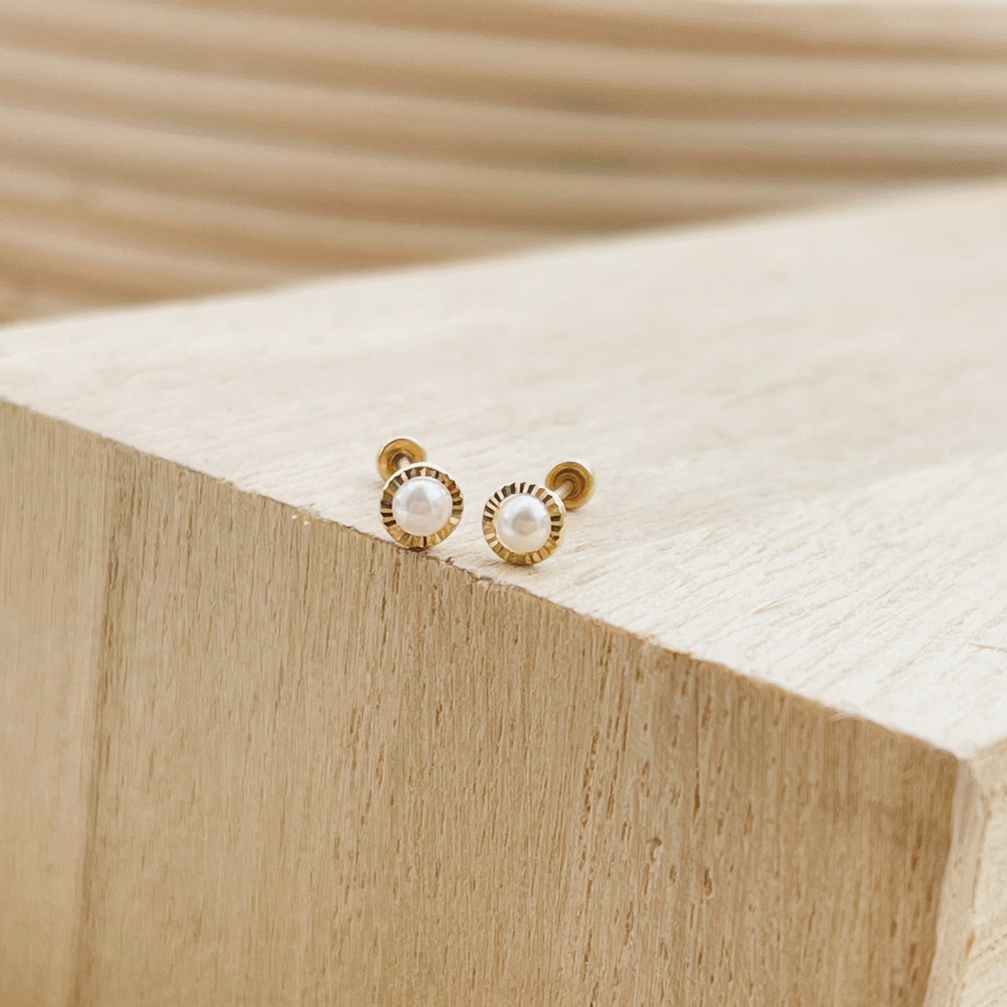 Load image into Gallery viewer, Delicate, but elegant. These 10 kt gold bezel set pearl earrings were designed for the woman who is proud of her beauty and ready to show it off!
