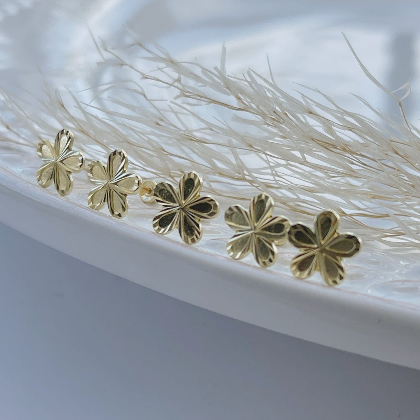 Dainty and delicate 10k gold flower stud earrings. These tiny, minimalistic earrings are perfect for everyday wear. They would also make a wonderful gift for the bridal party or flower girl!